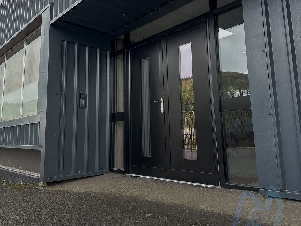 New black Shopline aluminium double doors with an Akuvox X912K intercom on the wall beside them