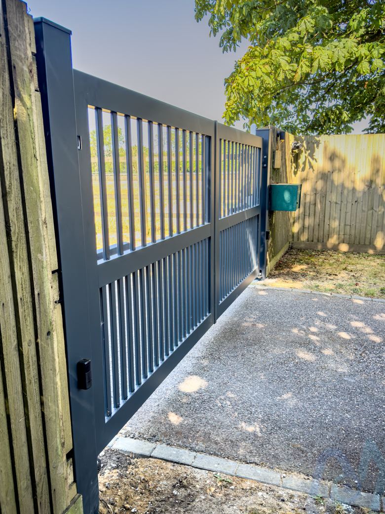 One gate leaf open, showing the slatted aluminium design