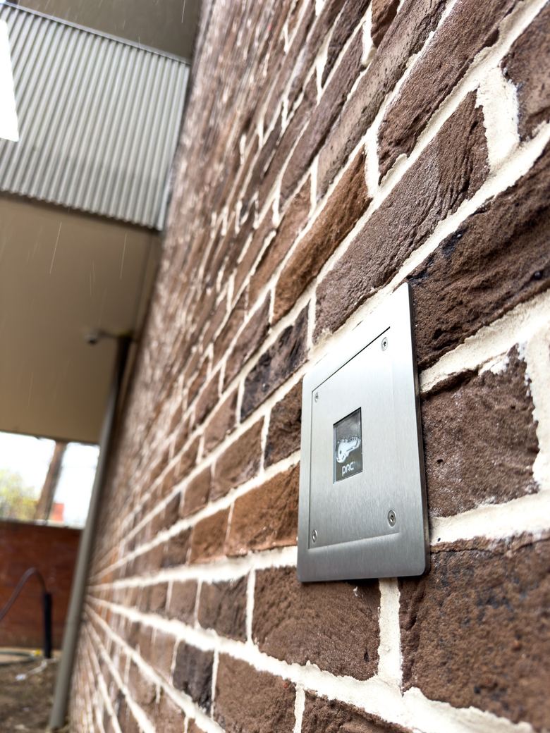 Flush stainless access control reader set into brickwork