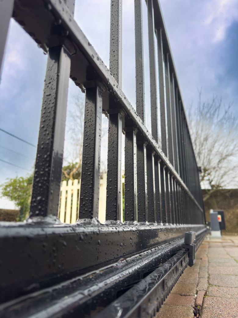 Close-up of the steel gate rail and bars