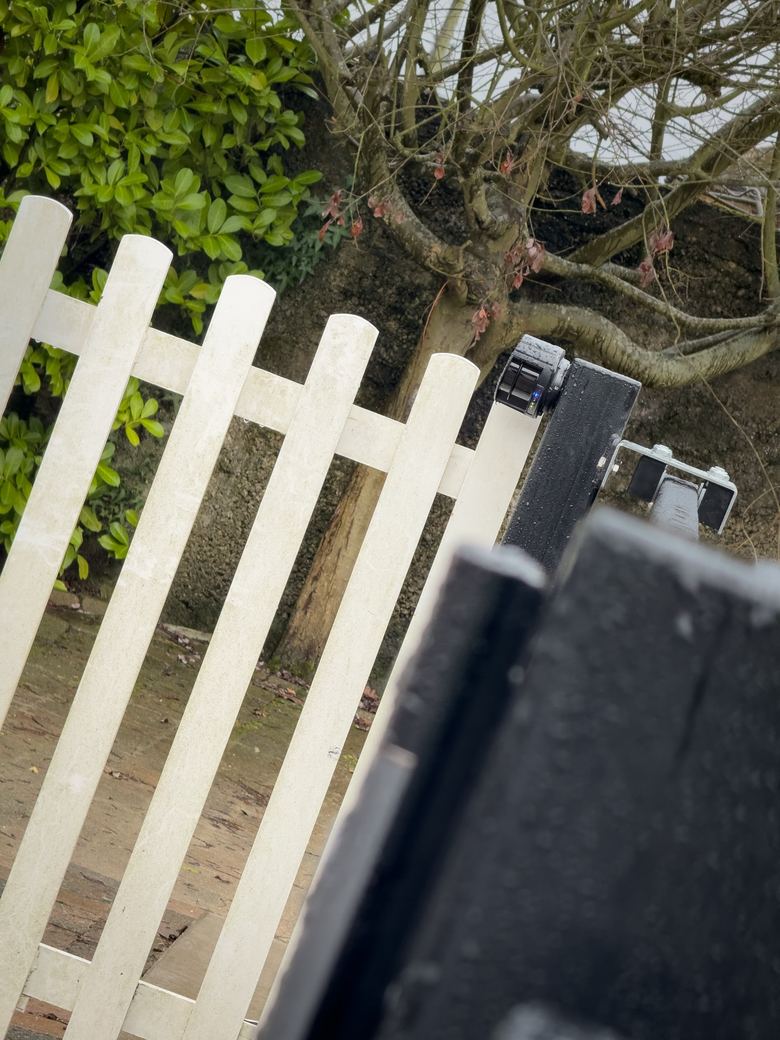 Safety laser on the gate post beside the picket fence