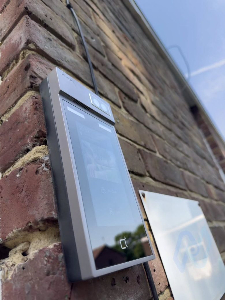 Akuvox S535 touchscreen video intercom on the brick wall at the school entrance