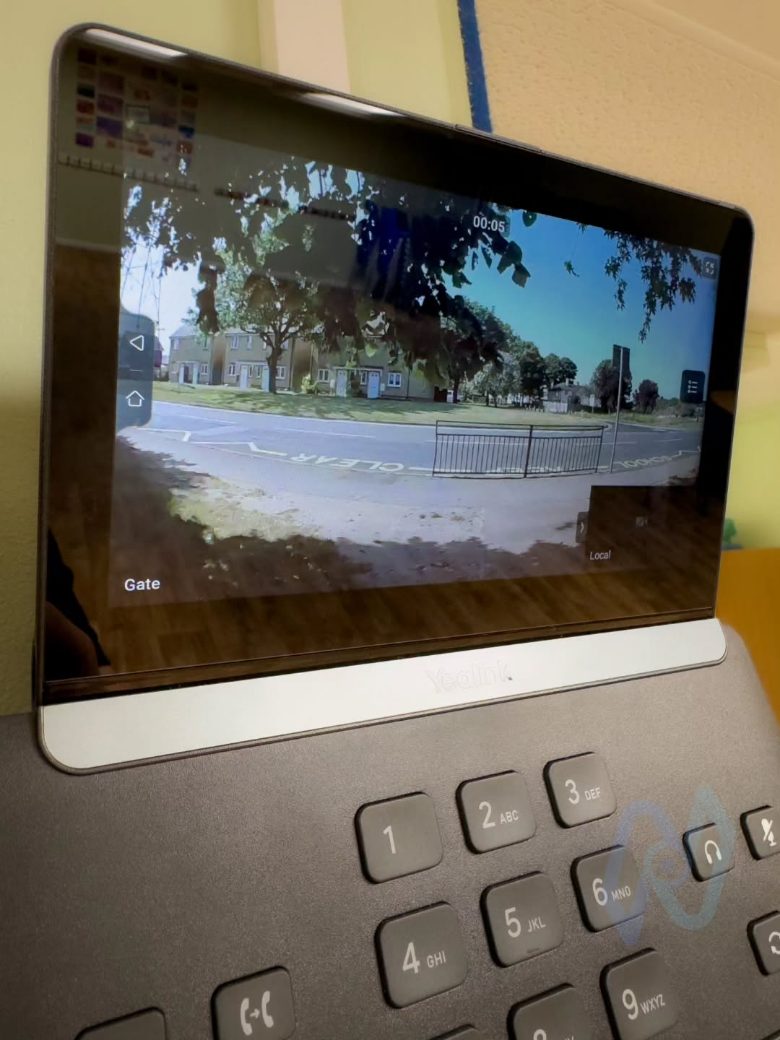 Live camera view of the school gate on a Yealink phone screen
