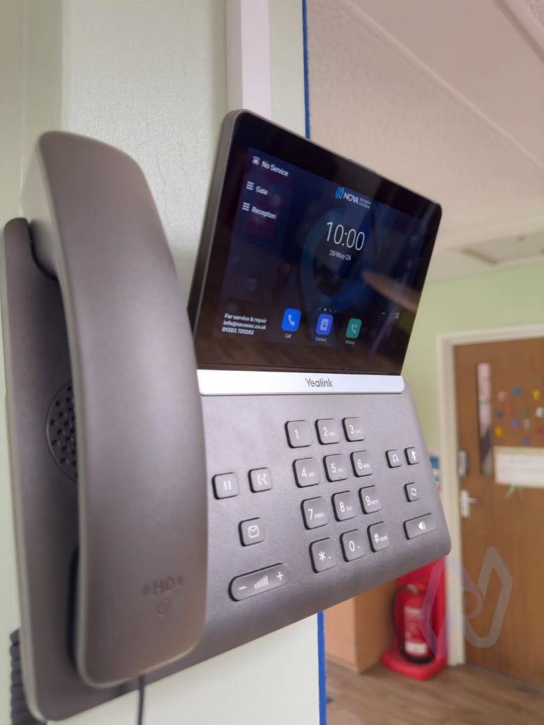 Wall-mounted Yealink IP phone in a school corridor