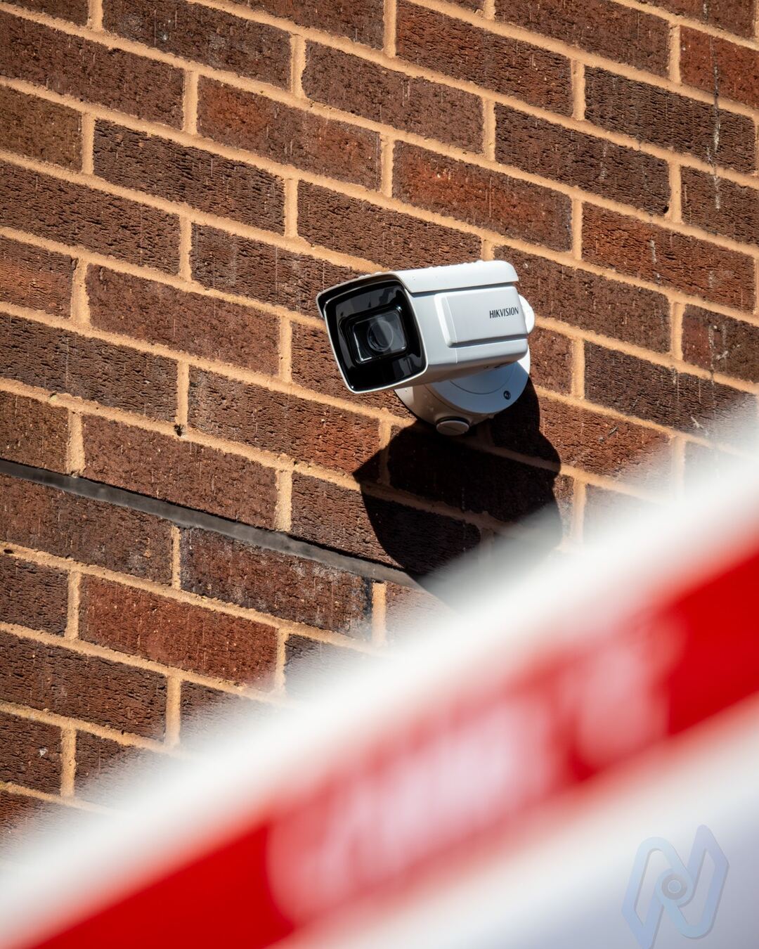Hikvision ANPR camera on the wall above the barrier boom