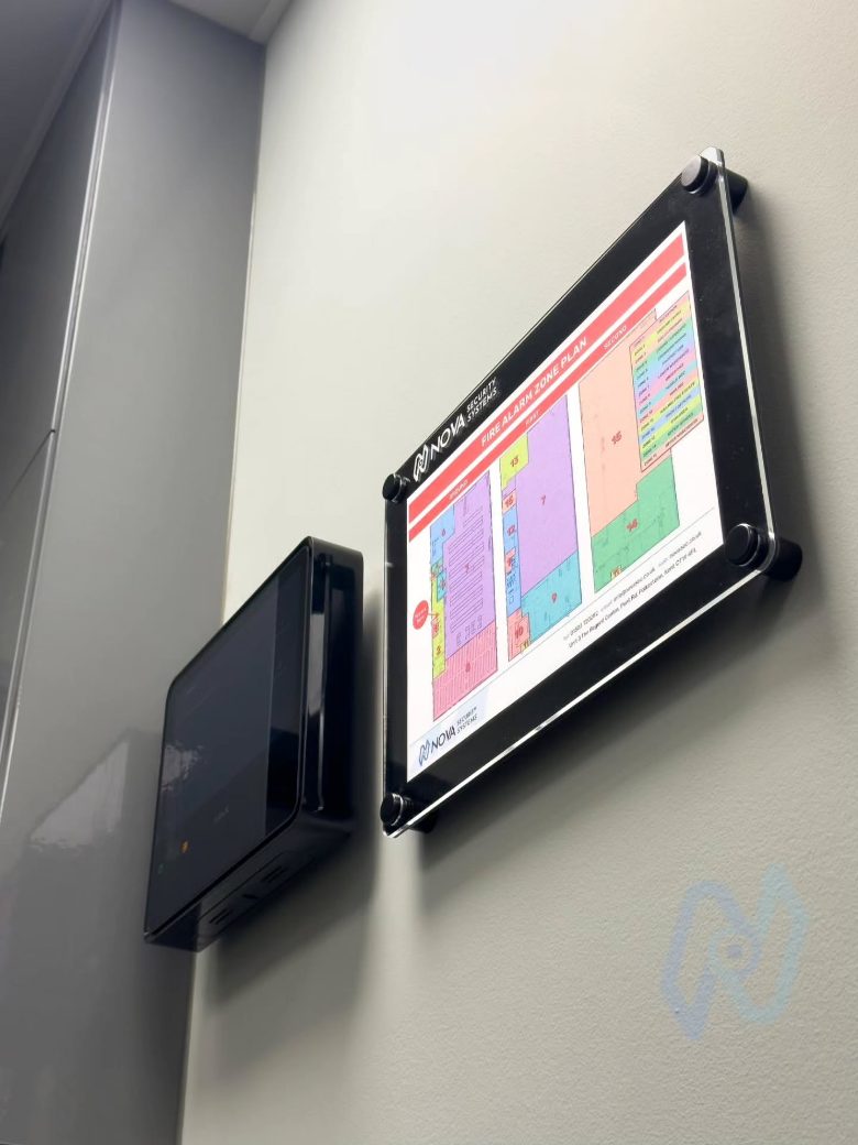 Ajax EN54 Fire Hub control panel beside a Nova framed fire alarm zone plan