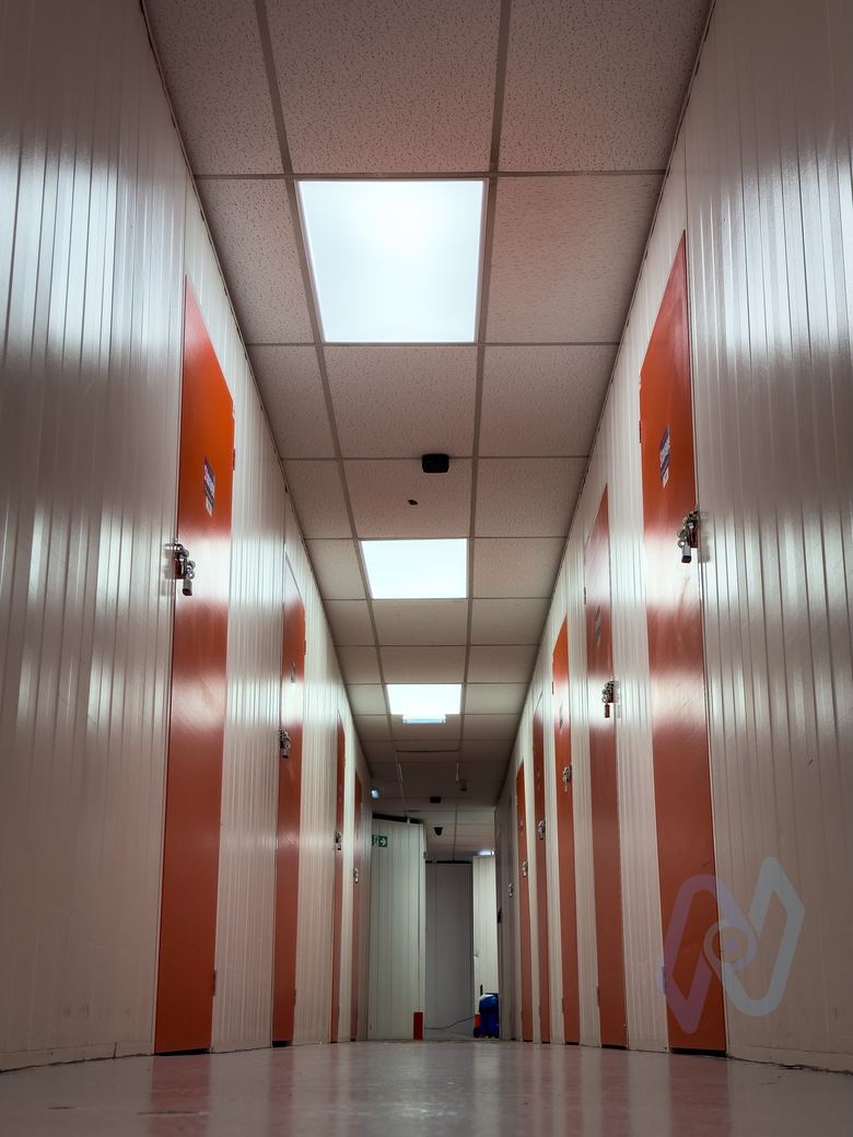 A corridor of storage units with metal walls