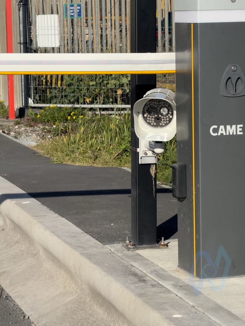 ANPR camera on a post beside a CAME barrier, reading vehicles in the entry lane