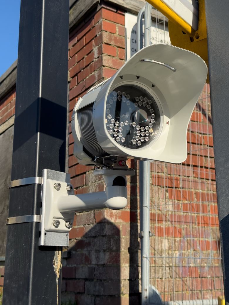 MAV AiQ ANPR camera on a bracket beside a brick wall