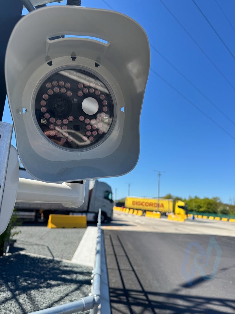 ANPR camera facing a truck yard with lorries in the distance