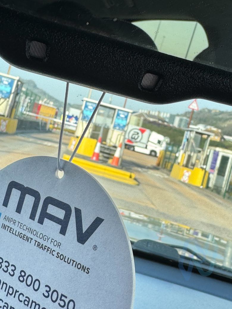 MAV ANPR technology tag hanging in a vehicle, with the port lanes beyond