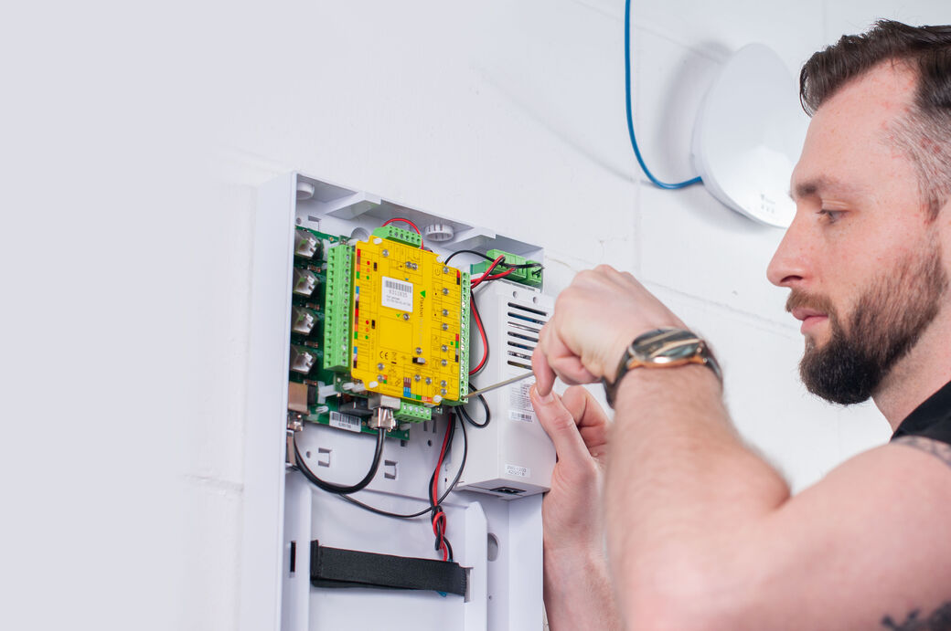 Engineer wiring a Paxton Net2 door controller