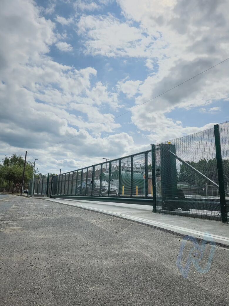 The cantilever gates and mesh fencing along the site boundary