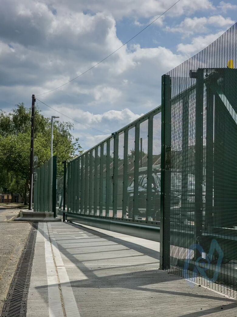 The cantilever gate rolled back along the fence line