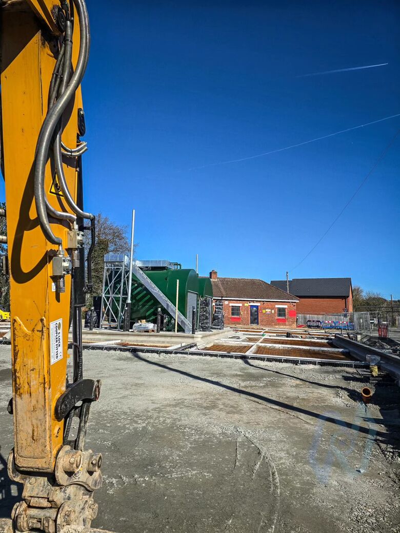 Groundworks for the gates under way, with an excavator on site