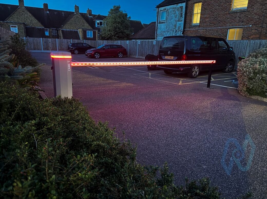 The red-lit boom down across the communal car park entrance