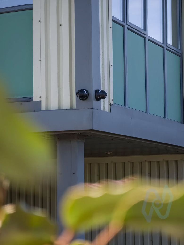 Two cameras under a walkway at the self storage site