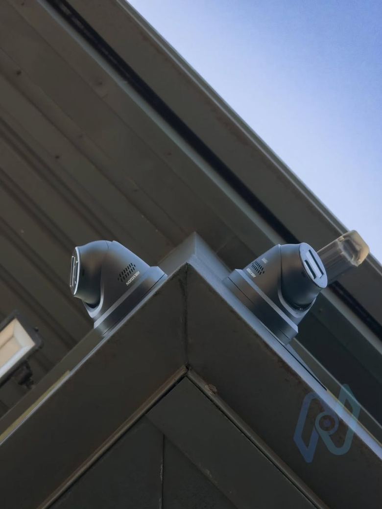Two cameras on the corner of a self storage building, covering both elevations
