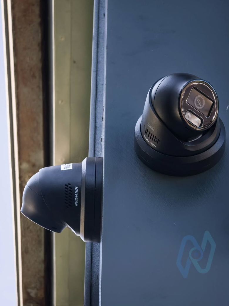 Hikvision turret cameras on a corner, black finish