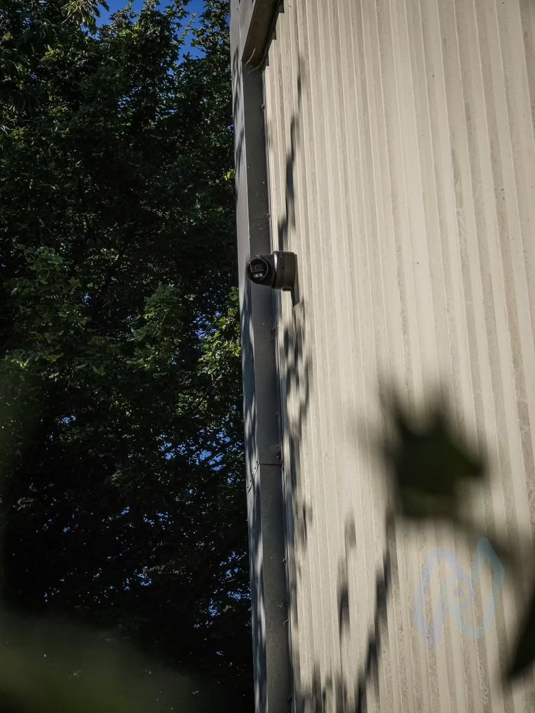 Camera high on the clad wall of a self storage building