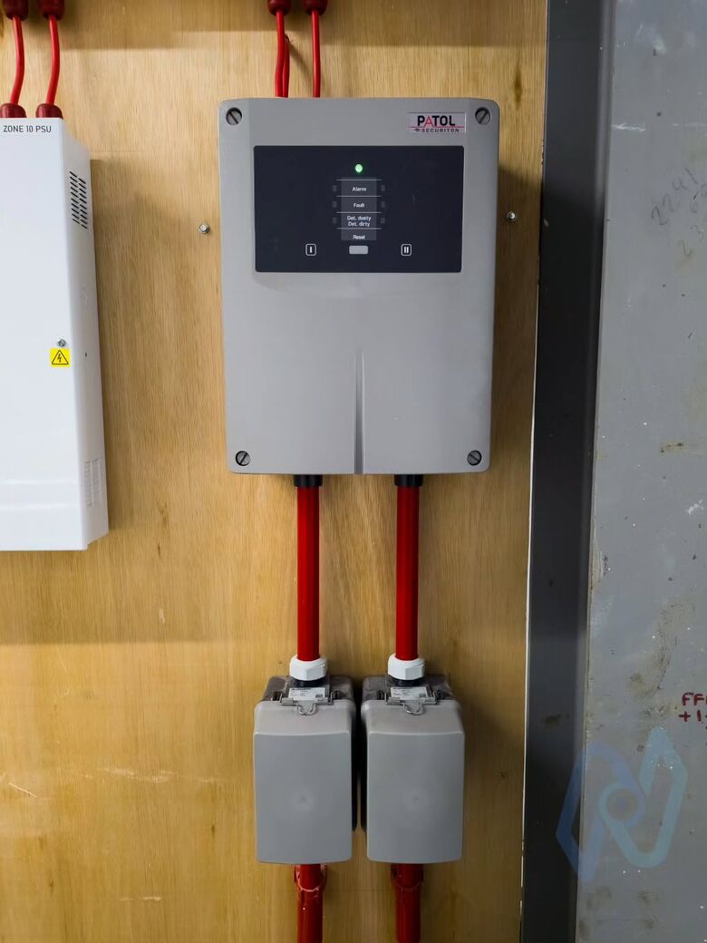 A Patol aspirating smoke detection unit with red sampling pipes