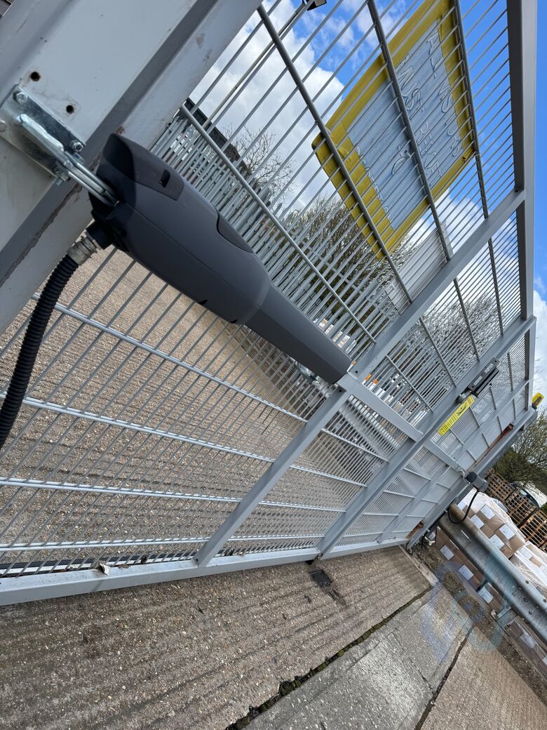 A CAME ATI ram motor on the leaf of a galvanised mesh gate