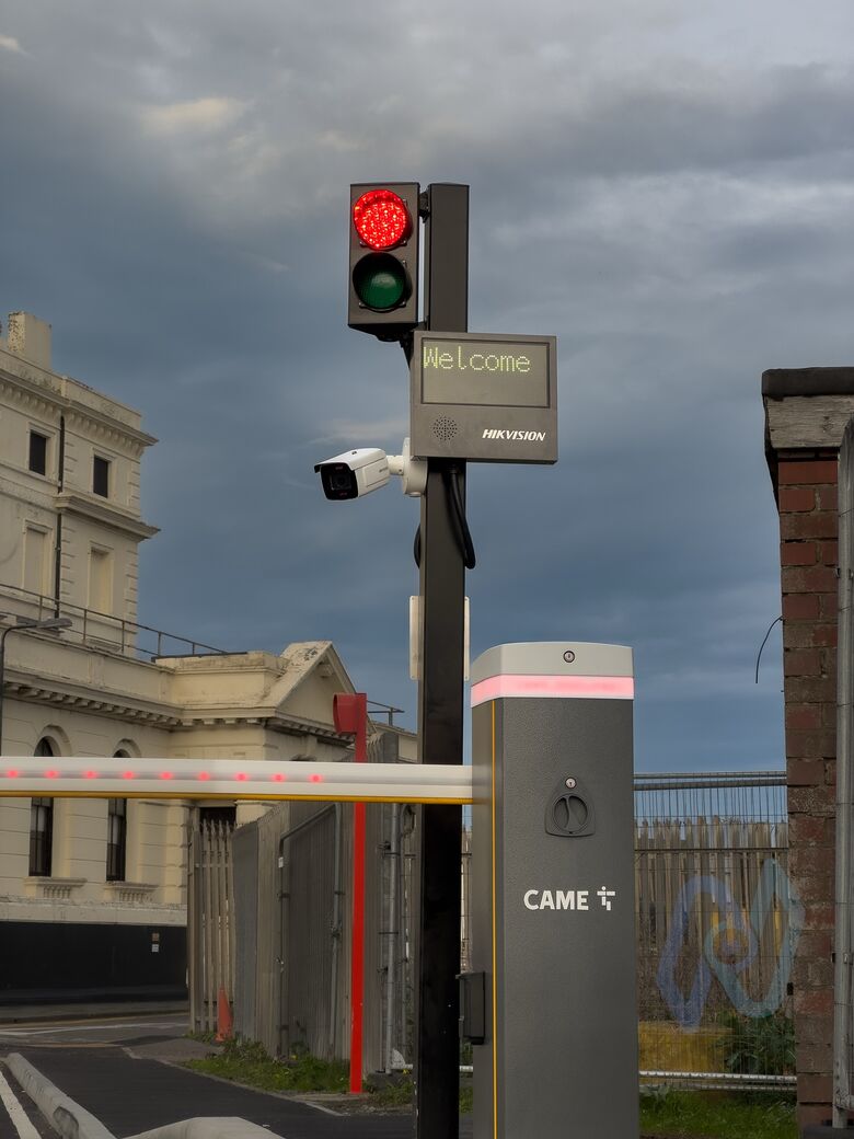 A CAME barrier at Motis Dover with a traffic light, a Hikvision ANPR camera and a welcome display