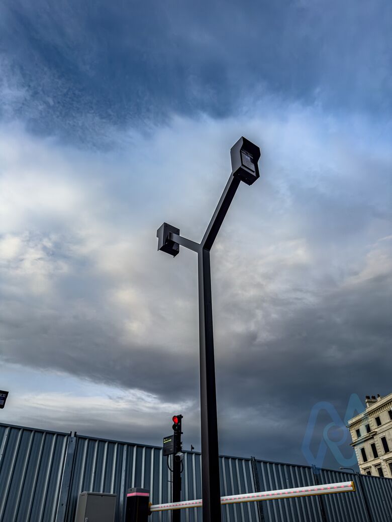 A dual-height intercom post beside a barrier lane at Motis Dover