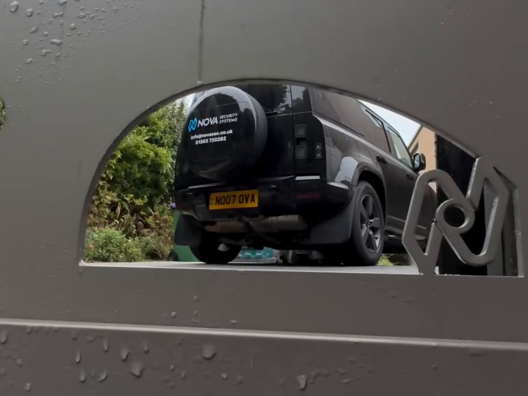 The Nova emblem cut into the custom gate, with a Nova vehicle seen through the opening