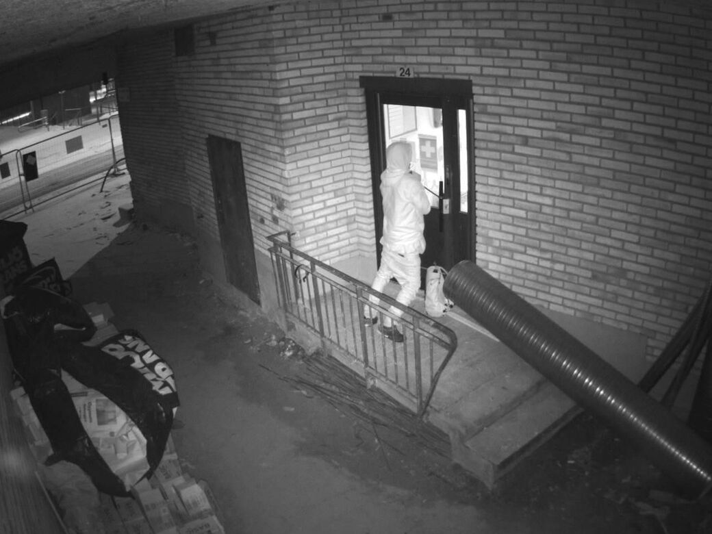 Night-time Reconeyez alarm photo of an intruder at the door of a building